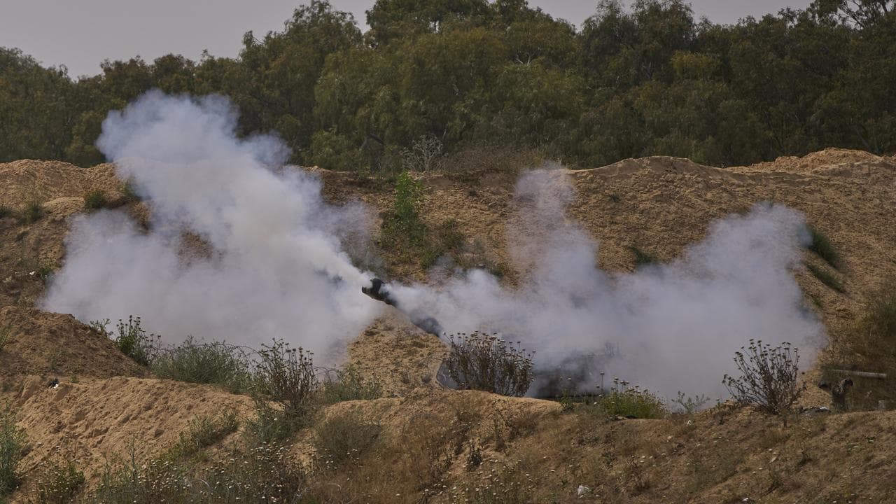 An Israeli mobile artillery unit fires towards the Gaza Strip