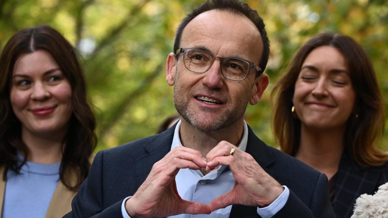 Adam Bandt making love heart symbol