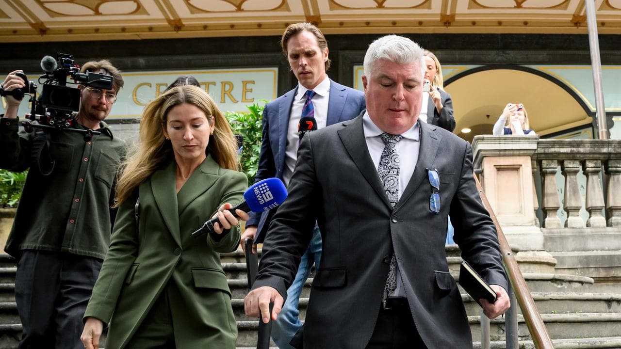 Stuart MacGill (right) departs the Downing Centre District Court i