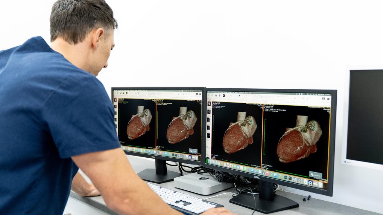 Staff at Spartan First Imaging look at a CT scan