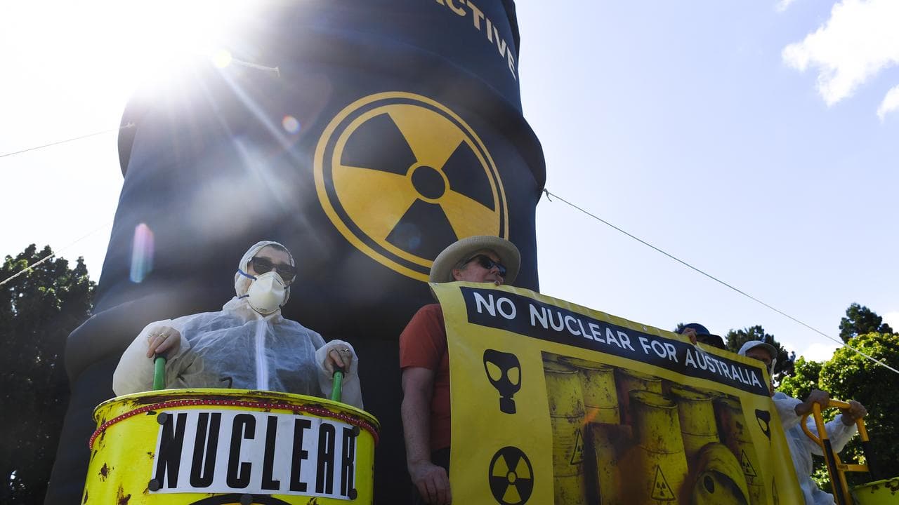 Activists with a prop radioactive waste barrel