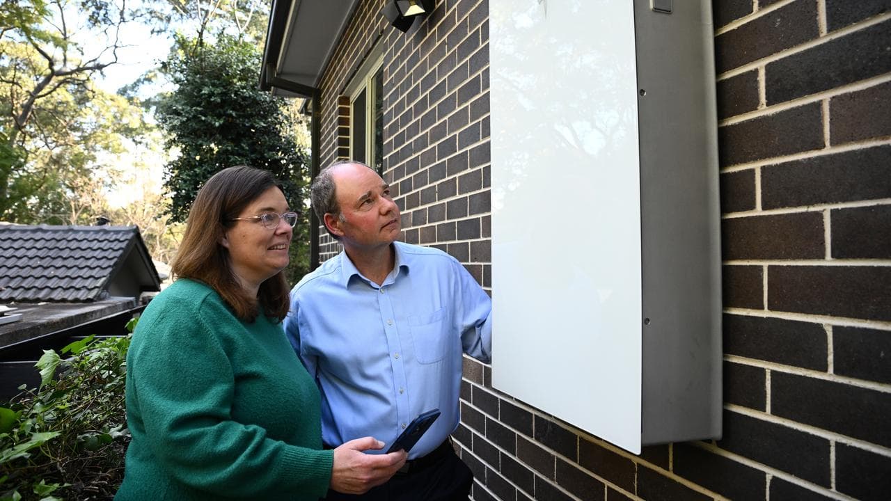 The Spencers with the Tesla Powerwall 3 at their Sydney home.