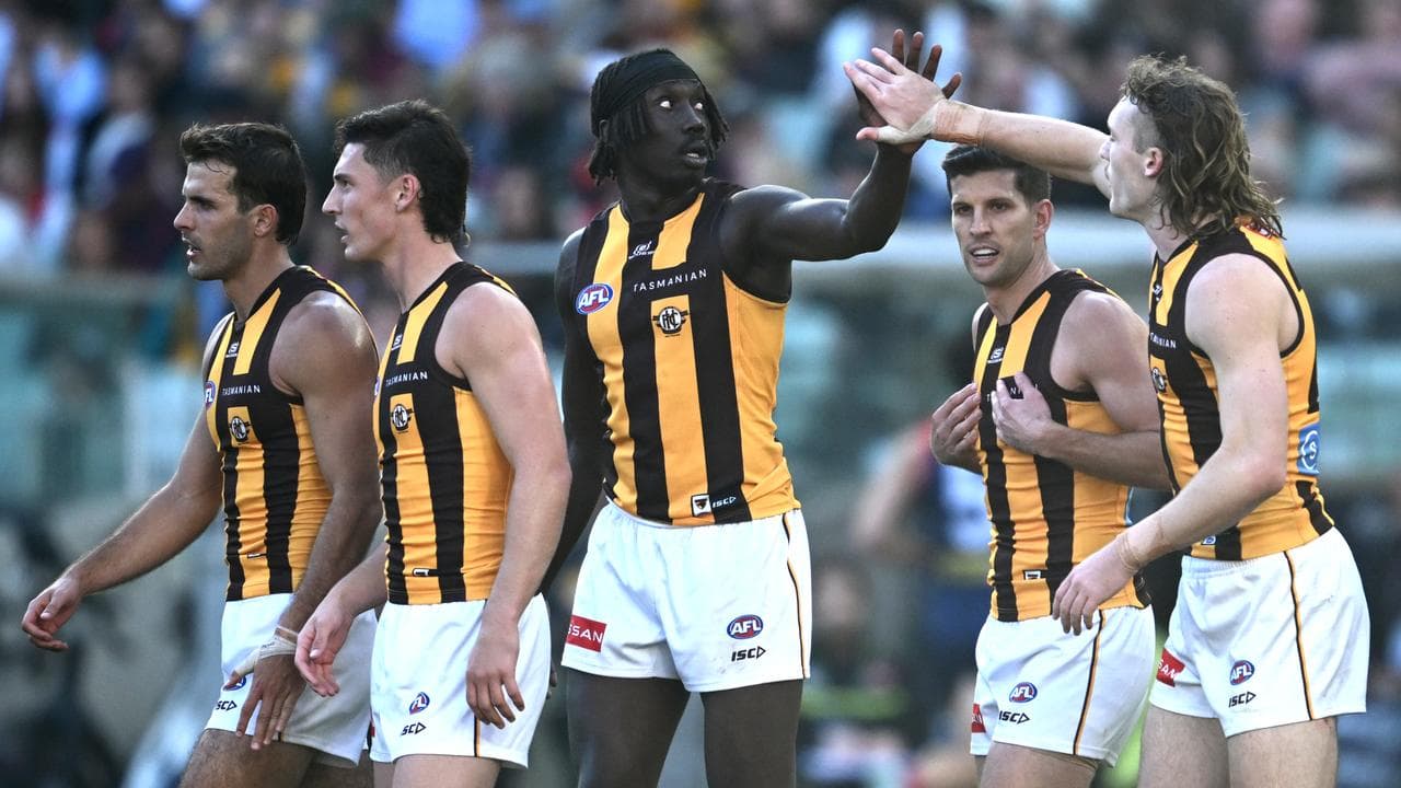Hawthorn teammates congratulate Mabior Chol (centre) 