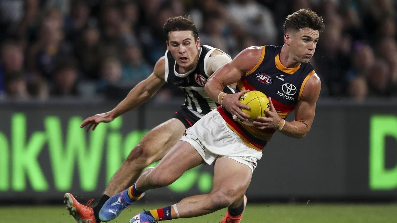 Ben Keays (right) evades Port Adelaide opponent Connor Rozee.