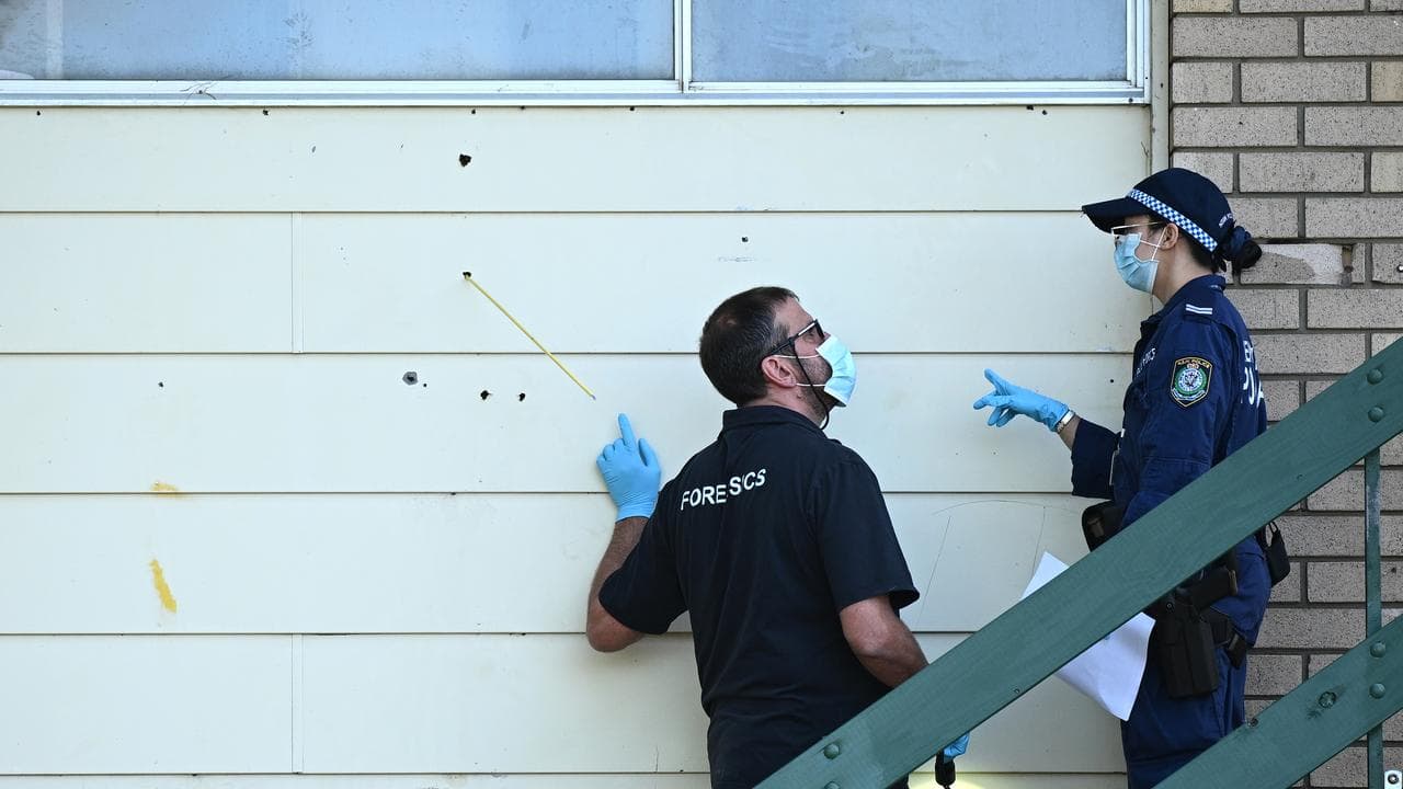 NSW Police rorensics officers inspect bullet holes (file image)