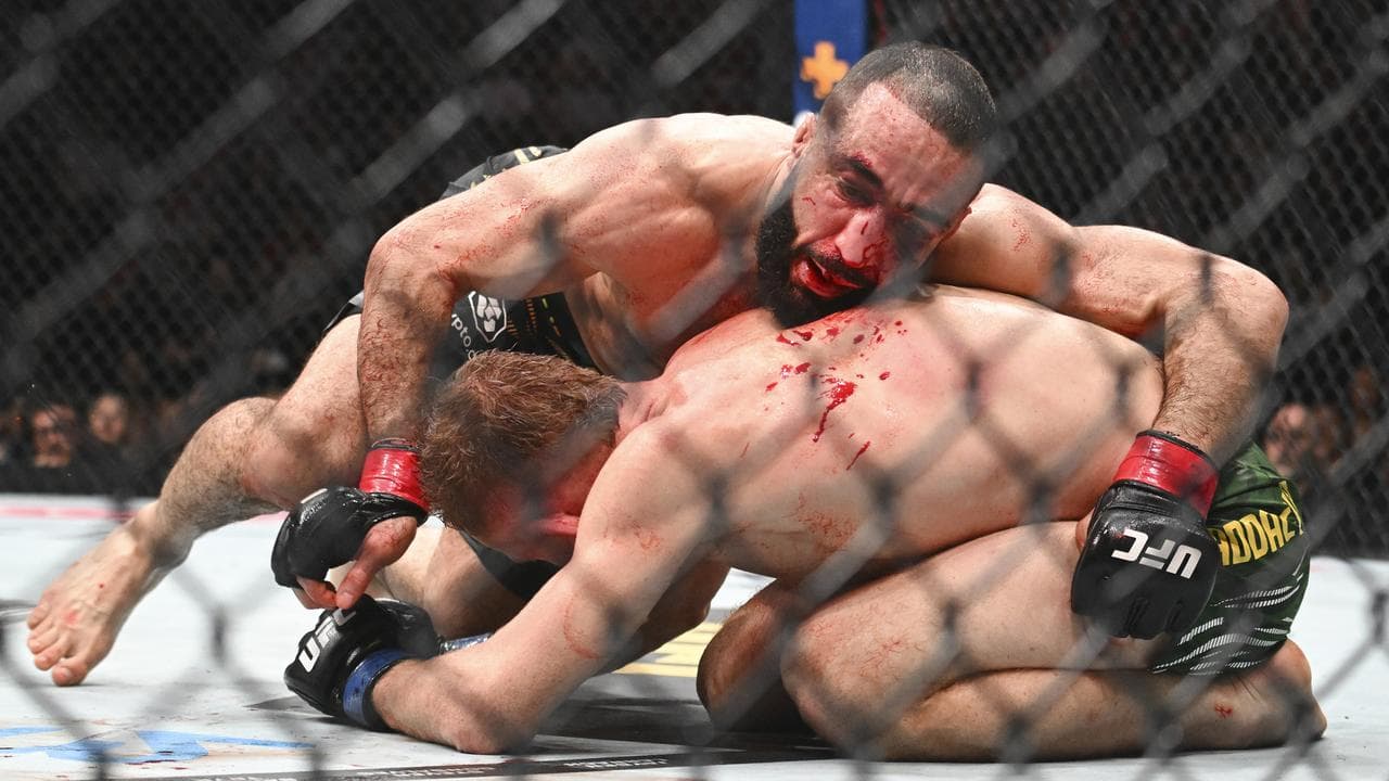 Belal Muhammad, top, applies top pressure