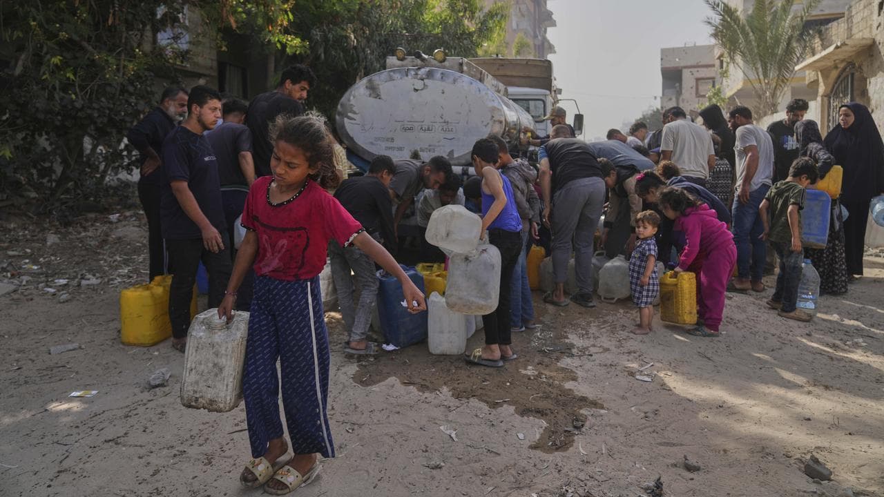 Palestinians collect water in jerry cans