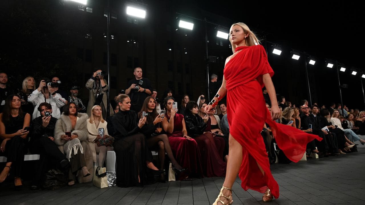 Model in red dress on runway