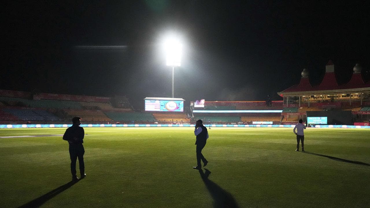 IPL officials in an evacuated stadium in Dharamshala, India.