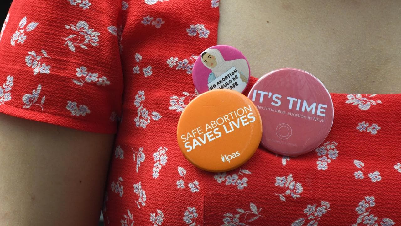 Pro-choice badges on a woman's dress