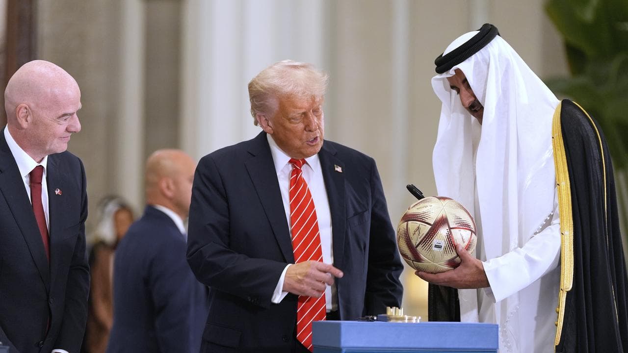 Donald Trump and Qatar's emir with a FIFA football in Doha