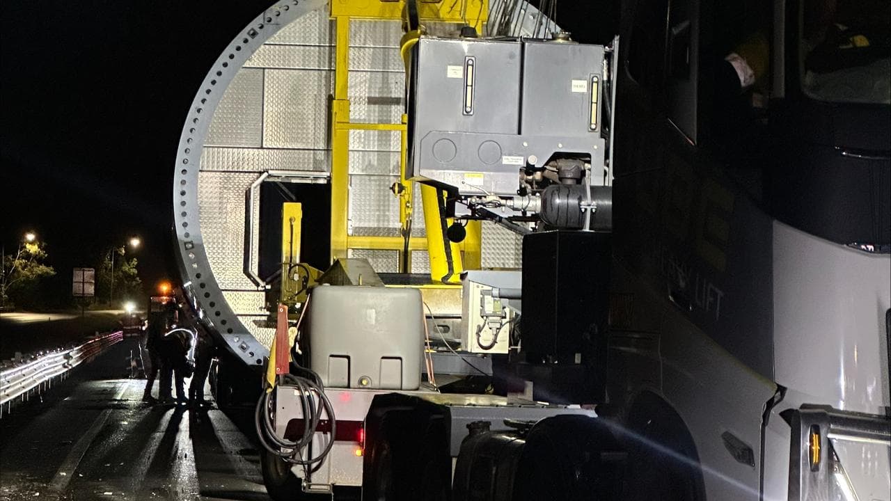 Wind turbine tower stuck under highway overpass