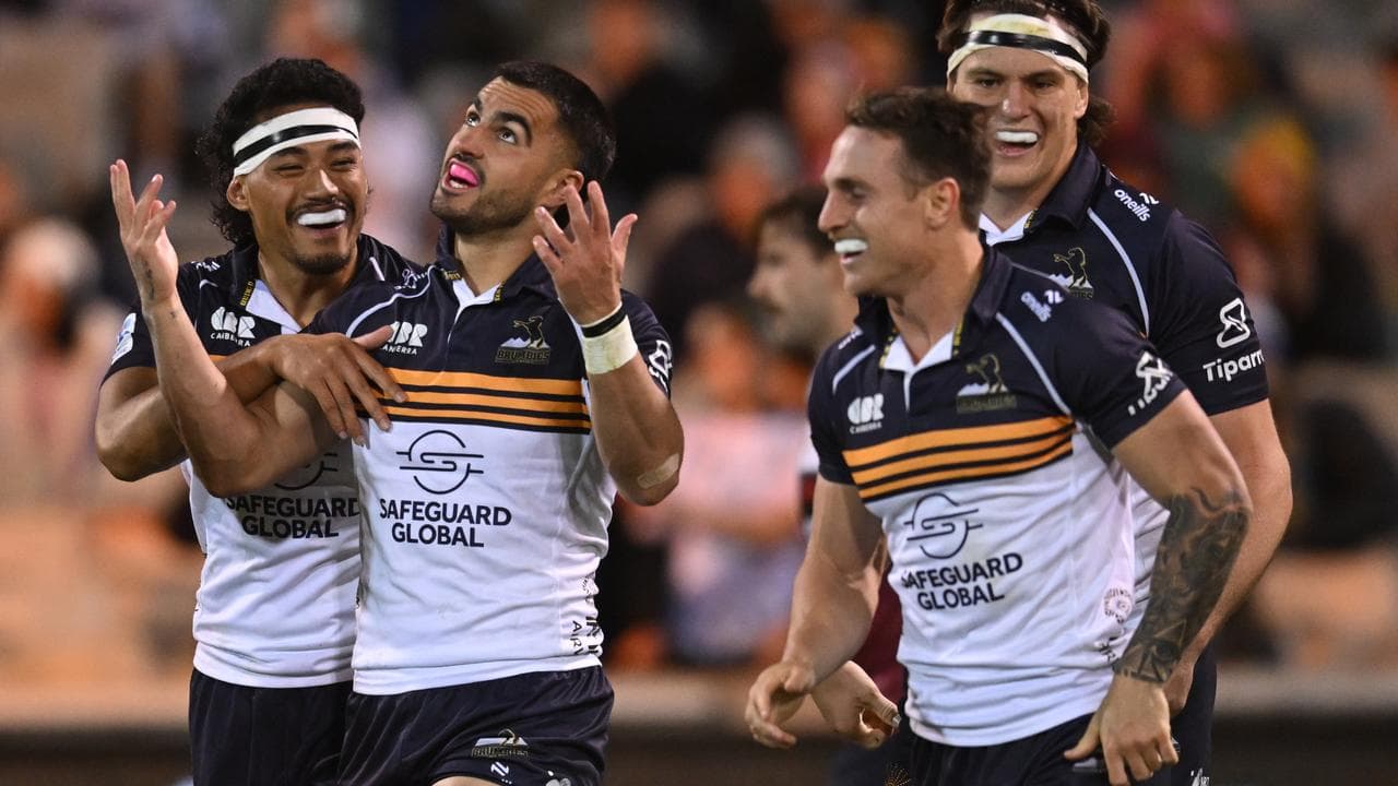 Tom Wright of the Brumbies celebrates after scoring a try.