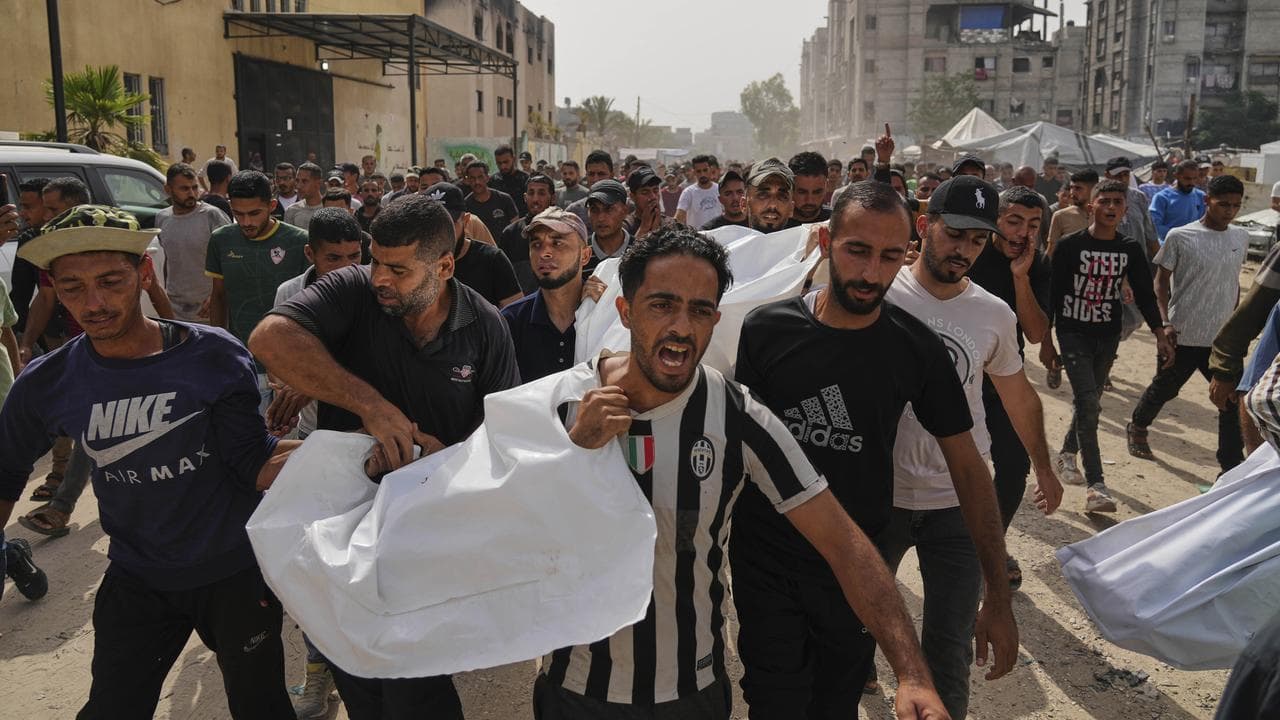 People carry the bodies of their relatives killed in an Israeli strike