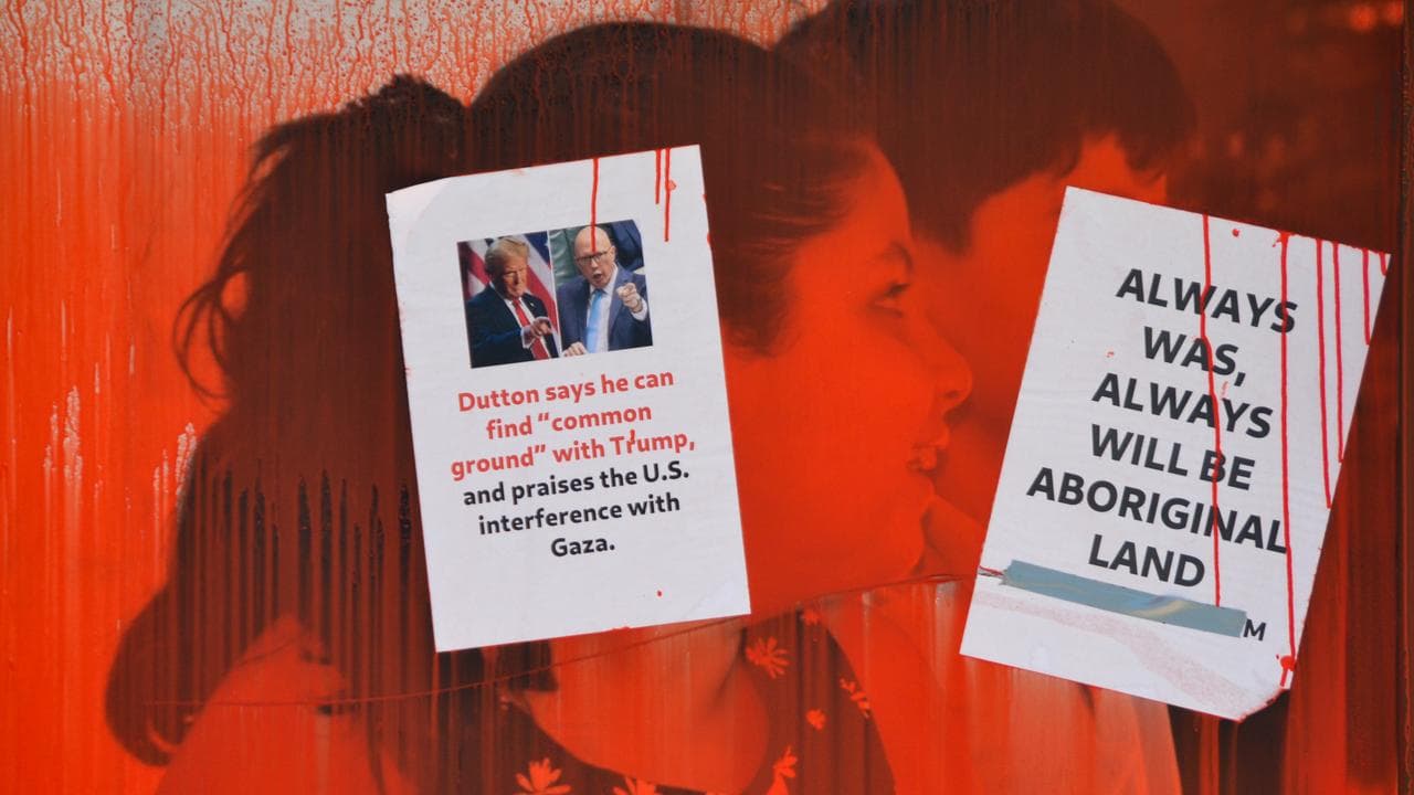 Red paint and paper posters cover the office windows (file)