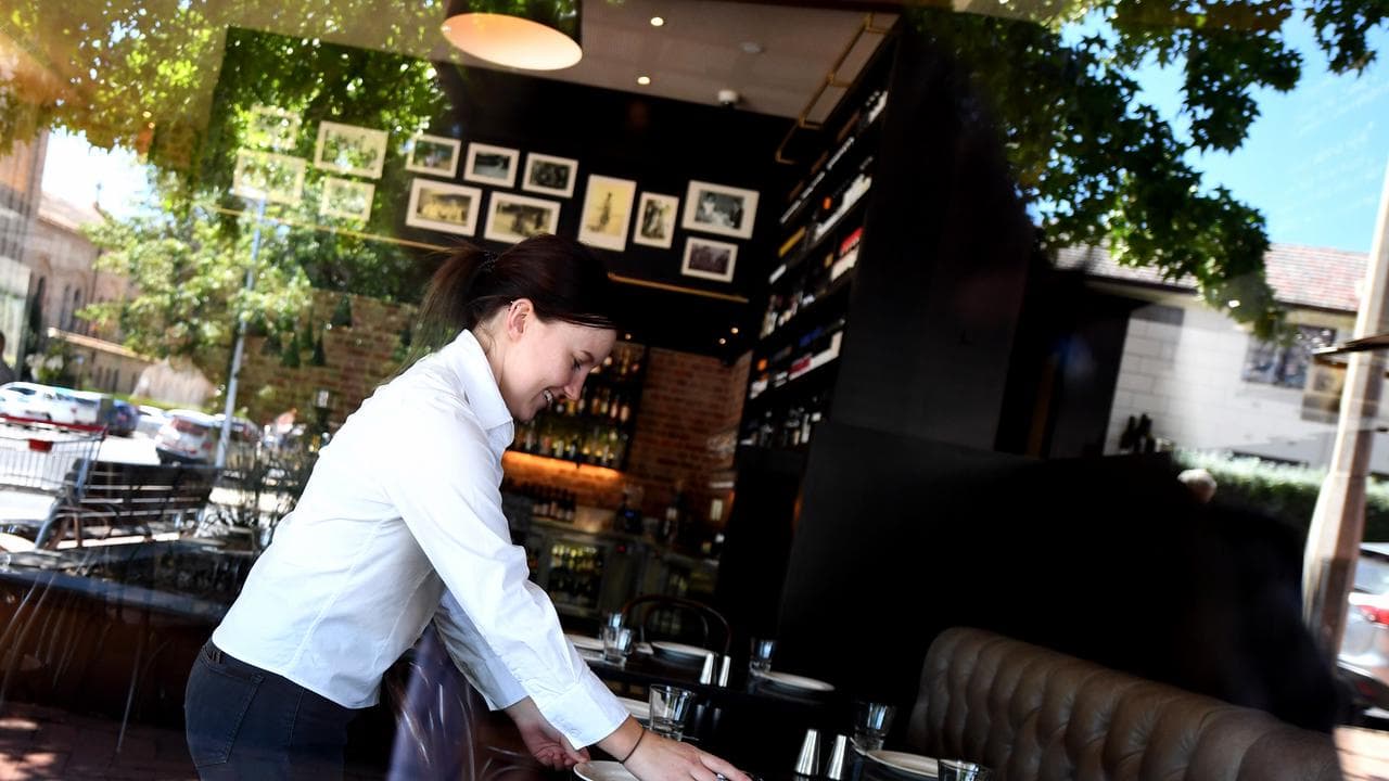 A waitress sets up a table at a restaurant (file image)