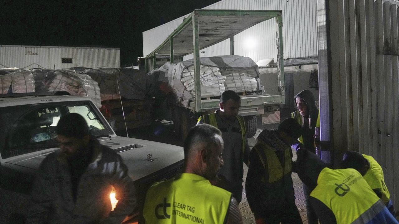 Aid trucks arrive at a World Food Program warehouse in the Gaza Strip