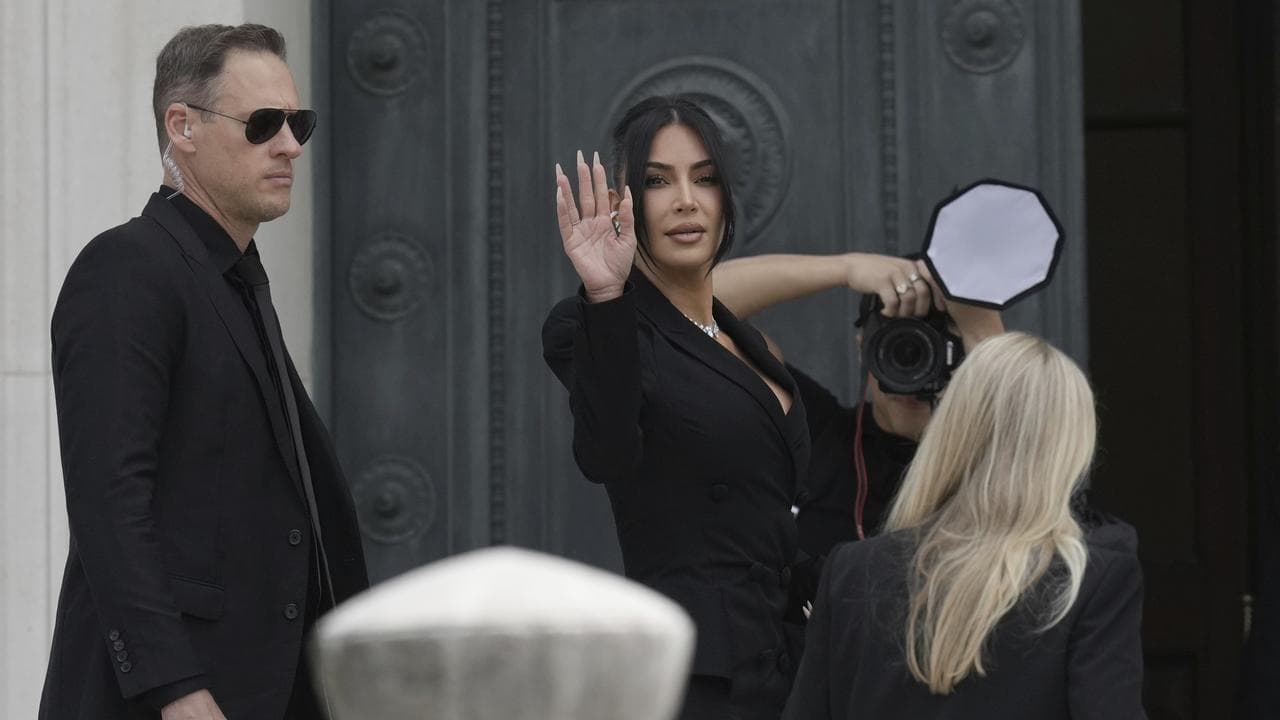 Kim Kardashian waves as she arrives at court in Paris