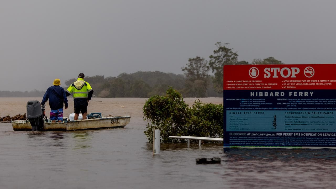 Peopel on a boat during flooding in Port Macquarie