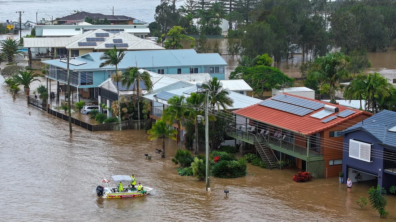 NSW Fire Rescue personnel assisting an elderly resident