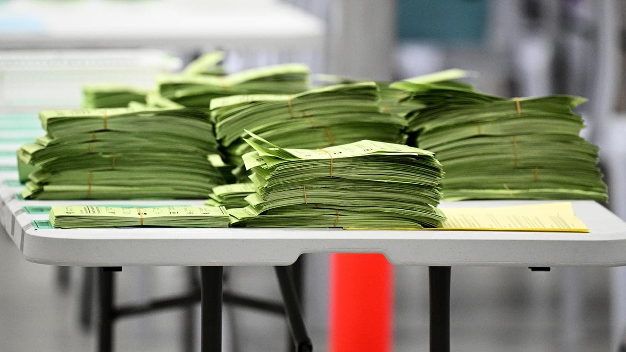 Australian Electoral Commission staff sort ballots