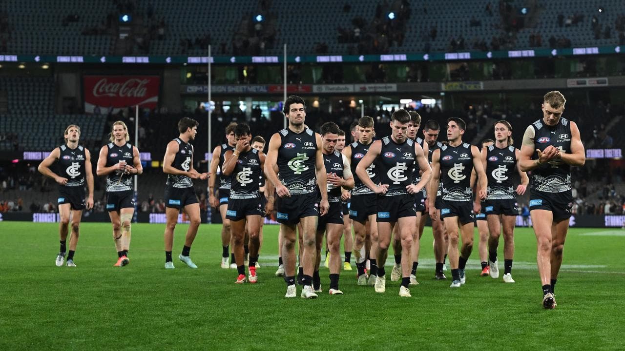 Disappointed Carlton players leave the field