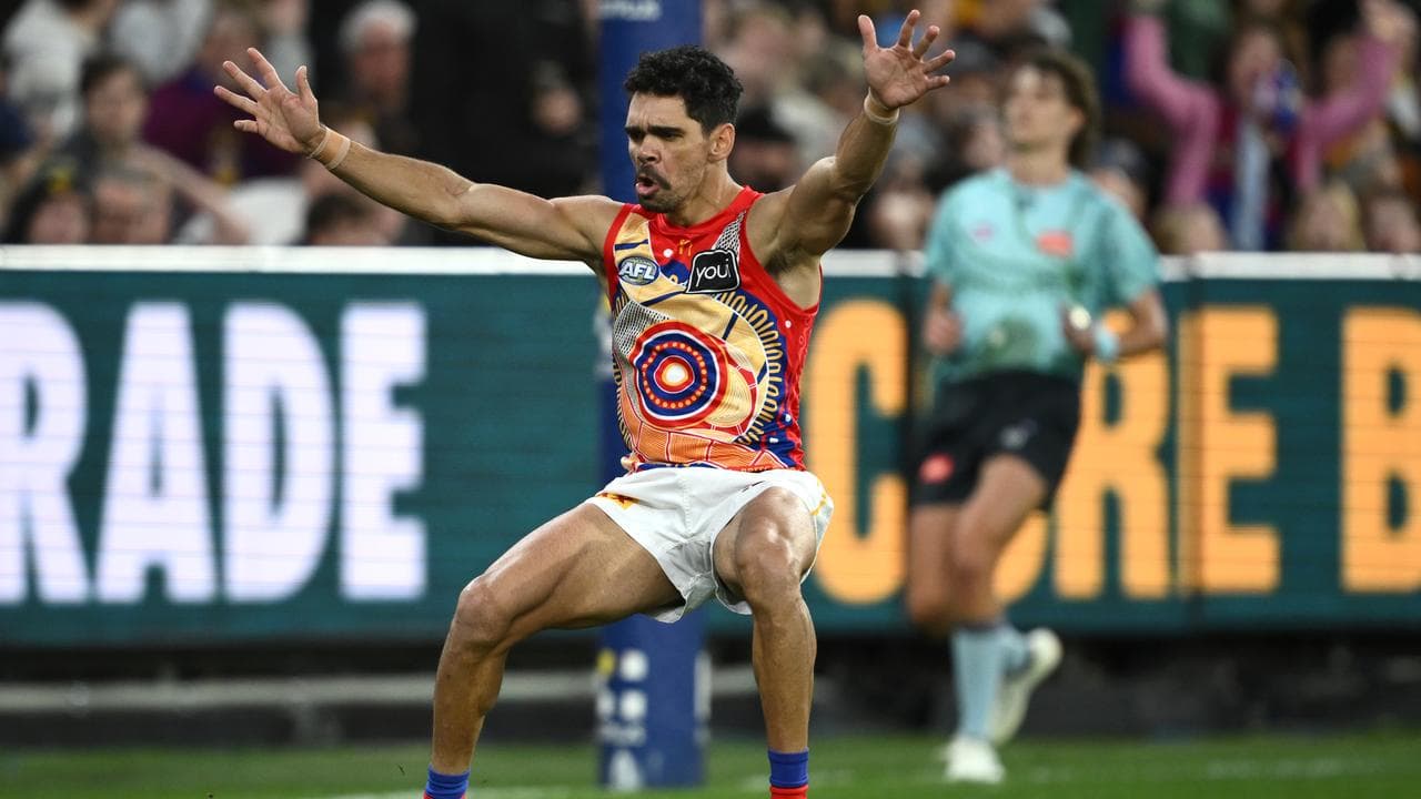 Charlie Cameron of the Lions celebrates scoring a goal