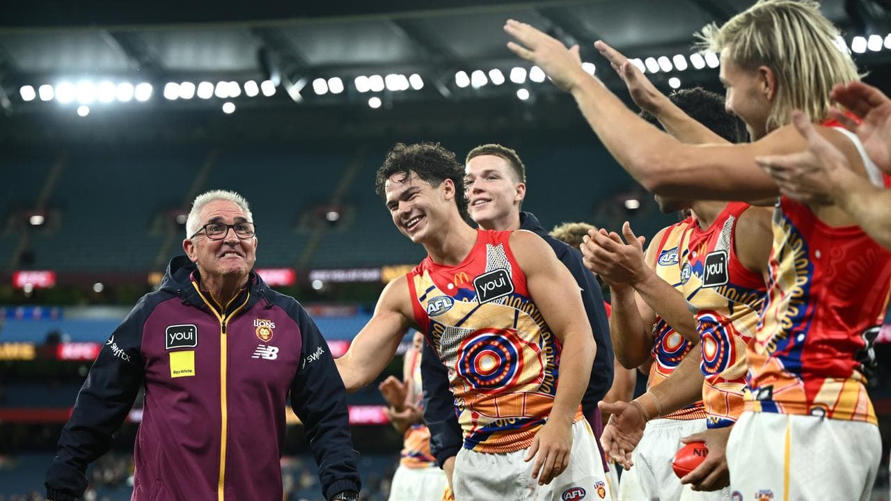 Brisbane players congratulate coach Chris Fagan (left)