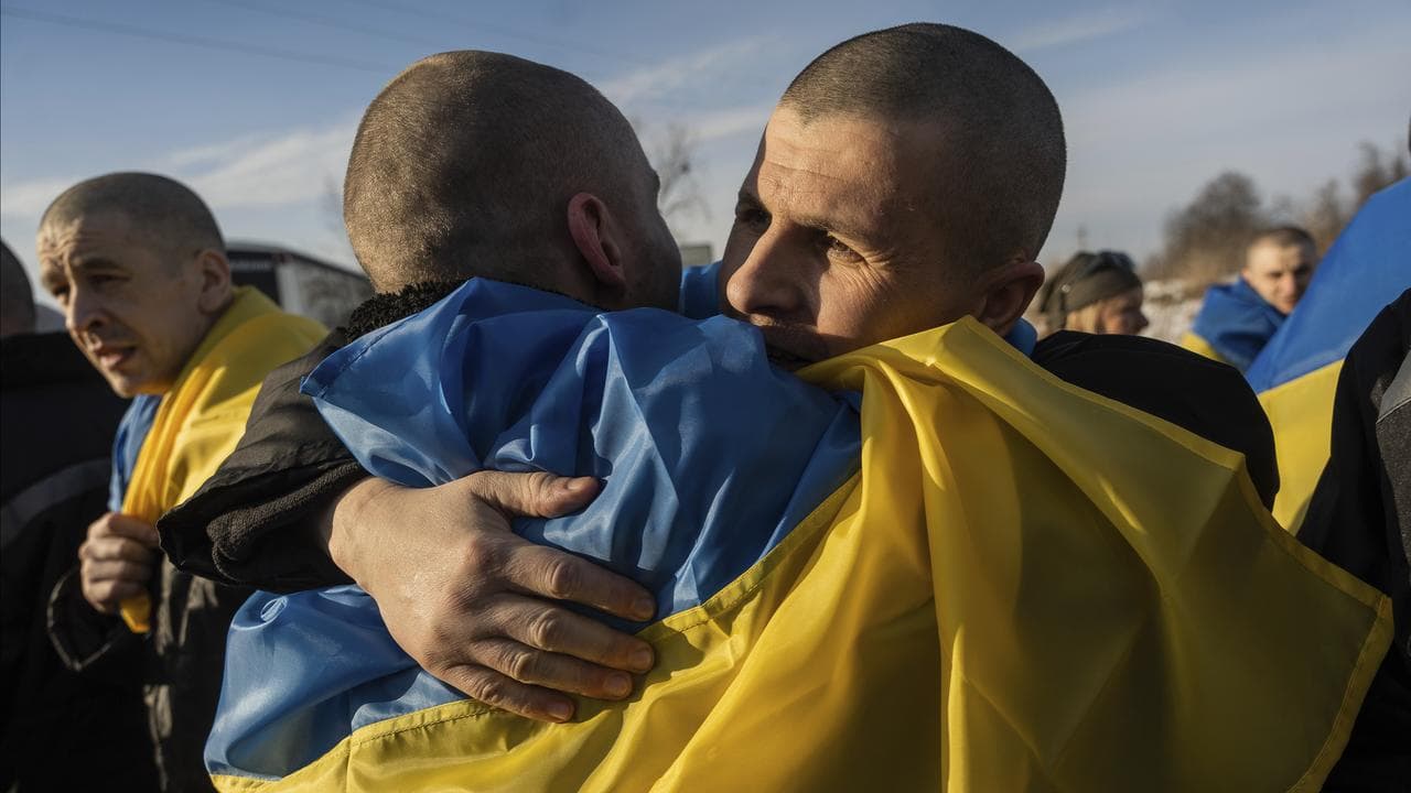 Swapped Ukrainian prisoners of war hug after a prisoner exchange 