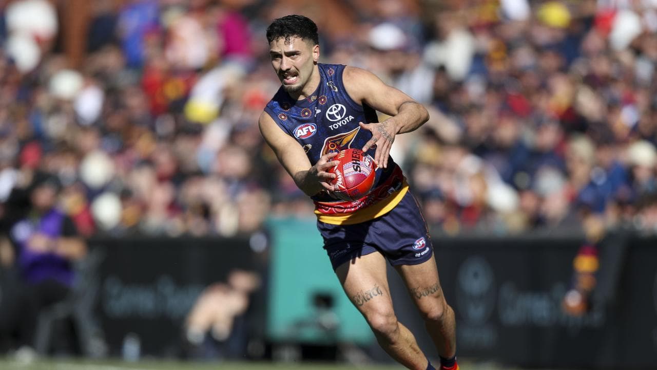 Adelaide's Izak Rankine looks upfield for a teammate