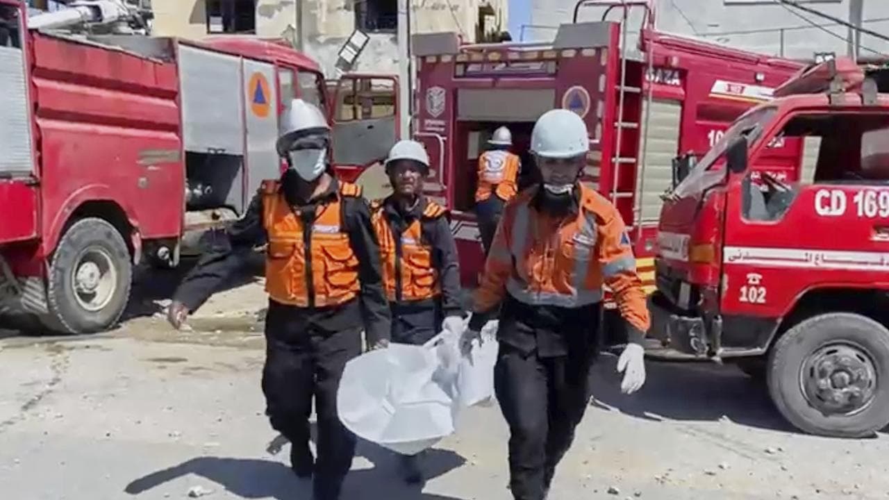 Workers collect human remains after an Israeli strike in Khan Younis