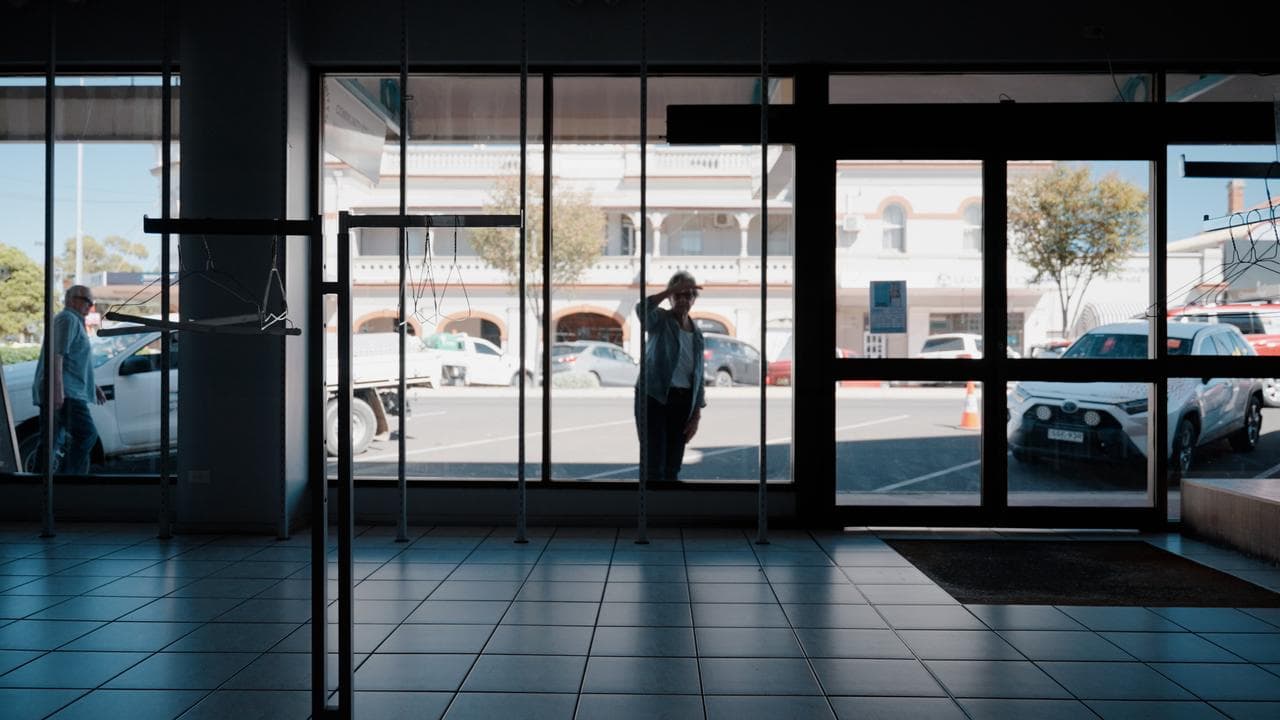 a woman seen looking into an empty shop in Narrabri