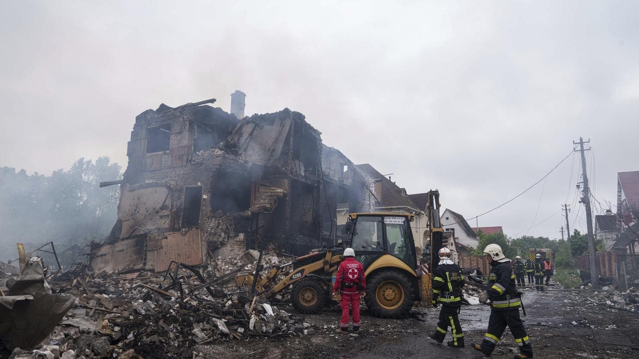Rescuers work after a Russian strike on a Kyiv region village