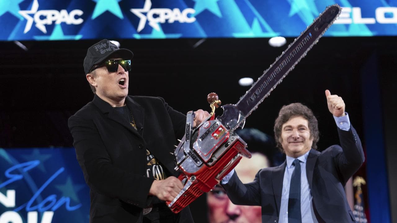 Elon Musk with a chainsaw in February