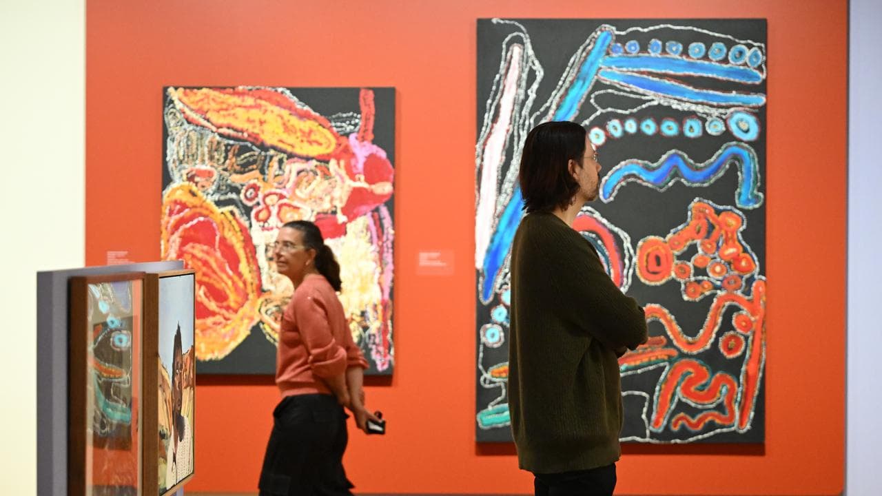 People observe artwork on display