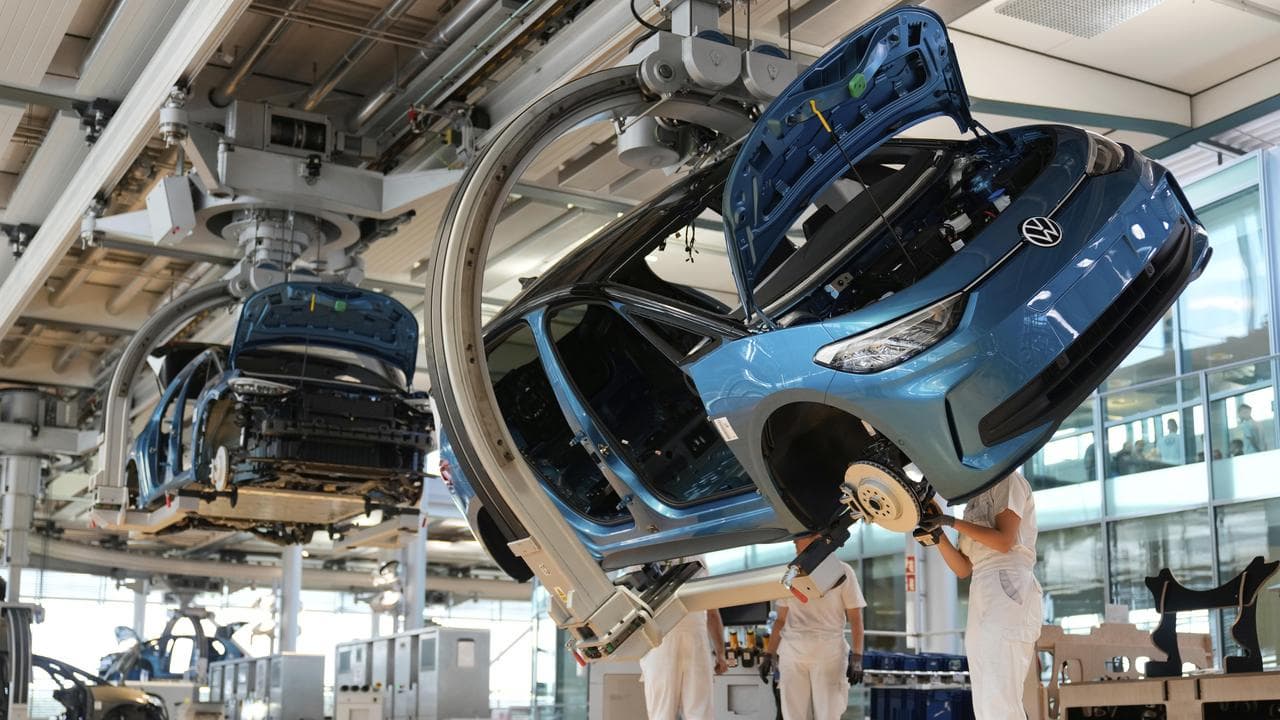 Workers and cars at a Volkswagen factory