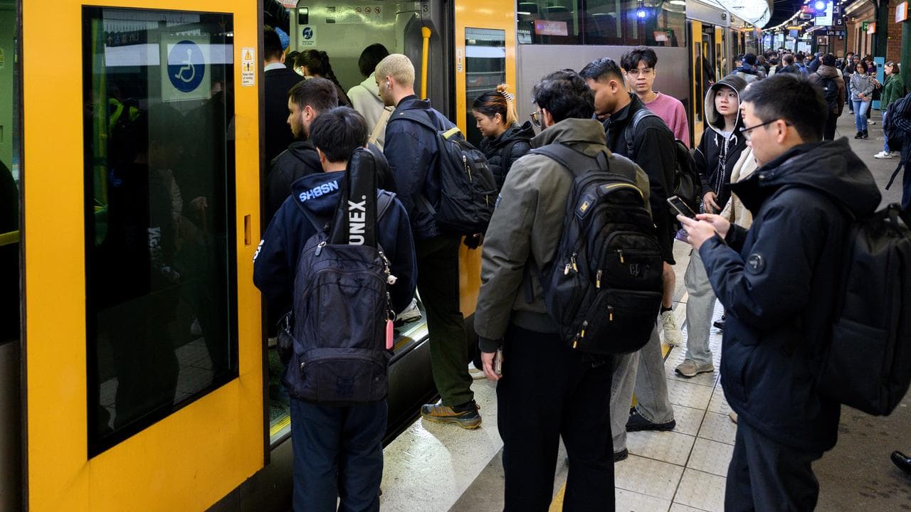 Commuters board a train at Strathfield Station in Sydney