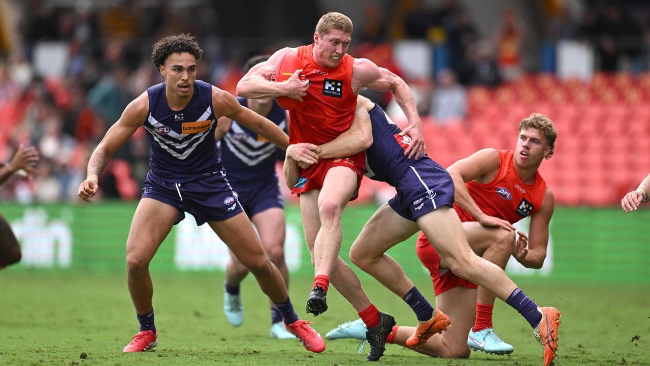 Gold Coast's Matt Rowell bullocks his way upfield against the Dockers.