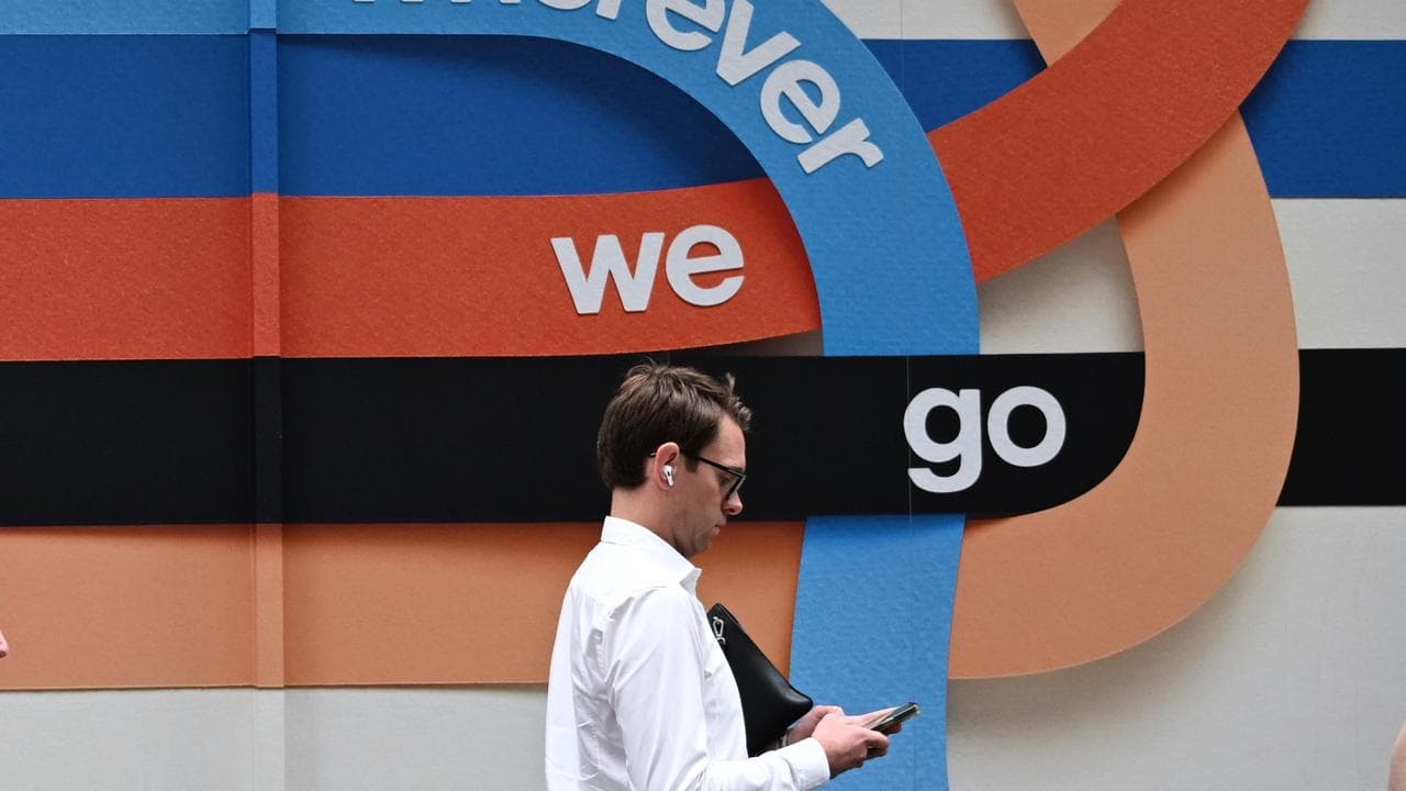 Person uses phone in Telstra store