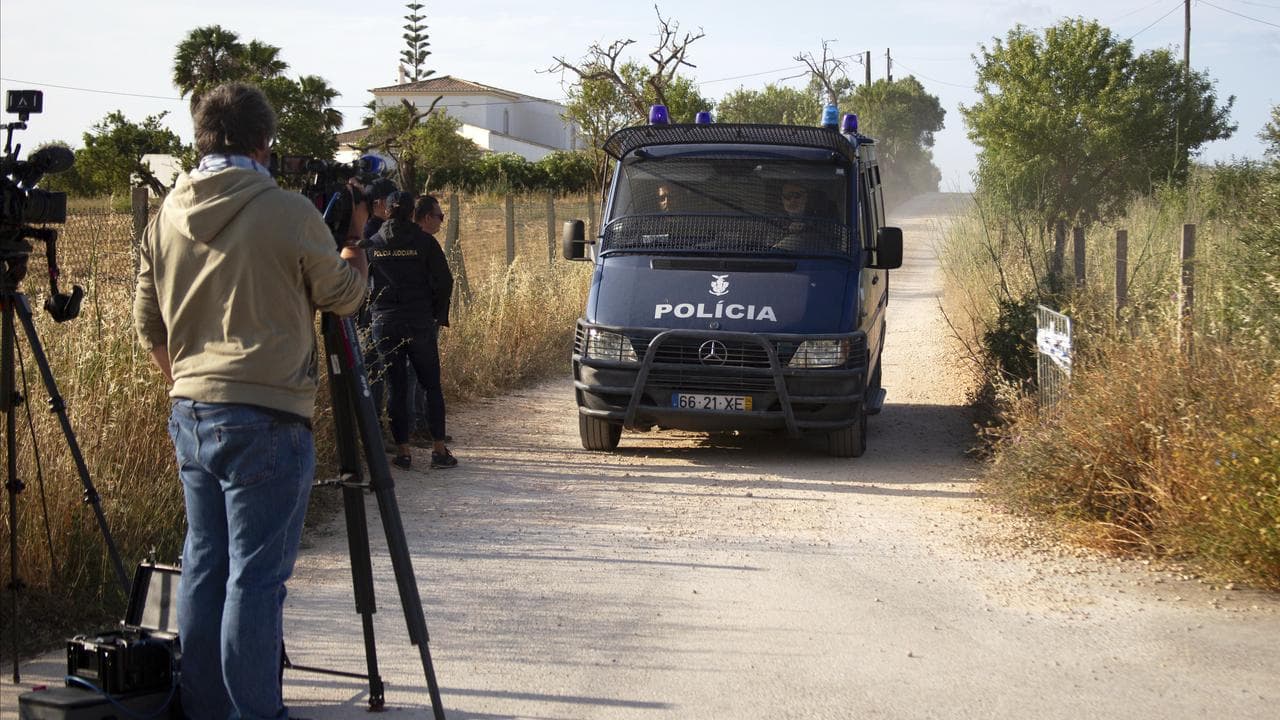 A Portuguese police van drives along a dirt road