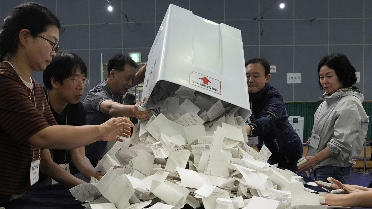 National Election Commission officials sort ballots for the election