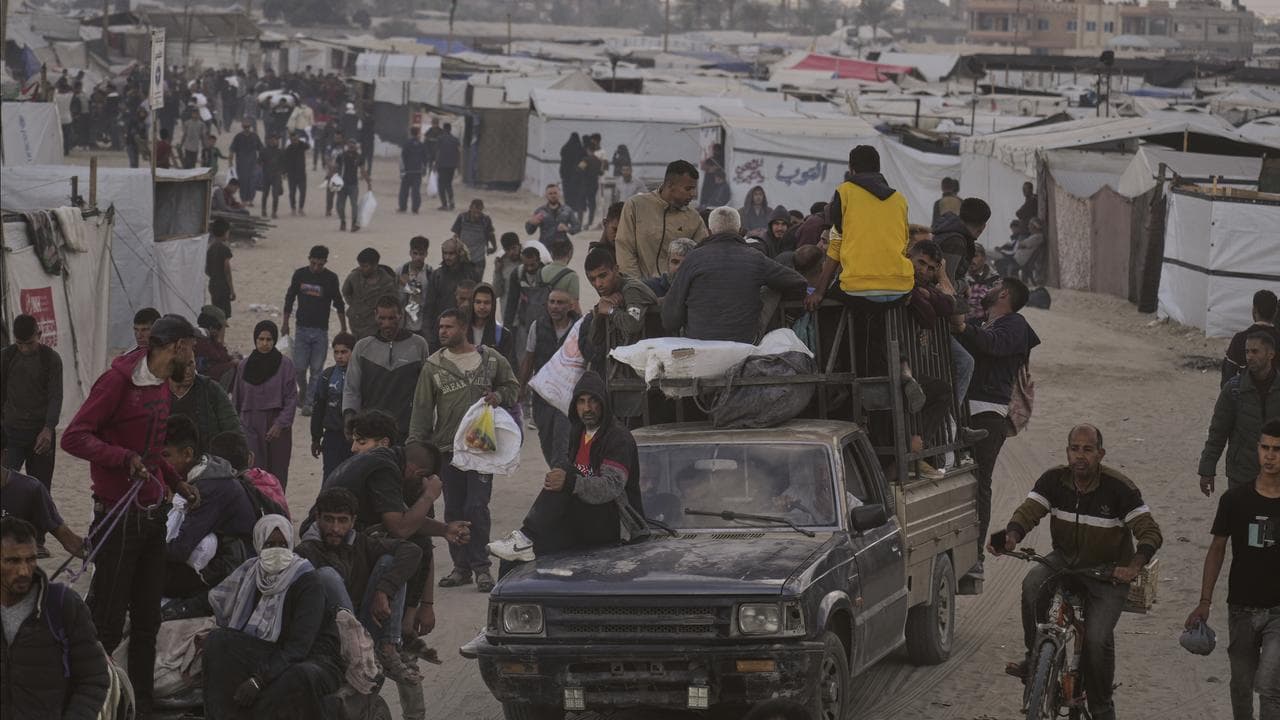 Palestinians carry bags filled with food and humanitarian aid