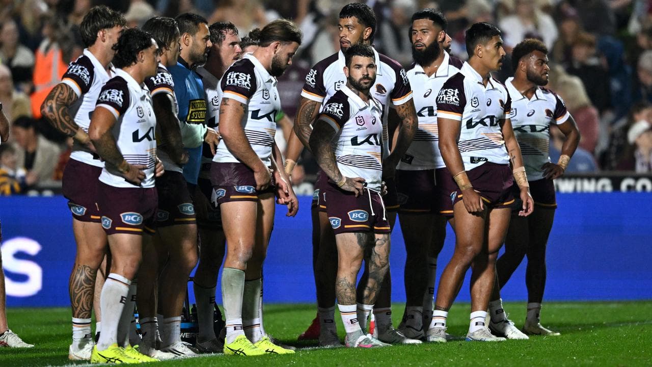 Broncos players stand dejected