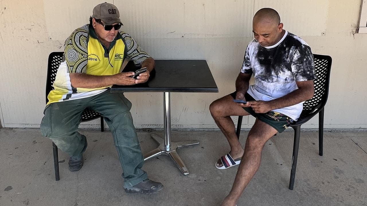 Residents use free wi-fi outside a supermarket