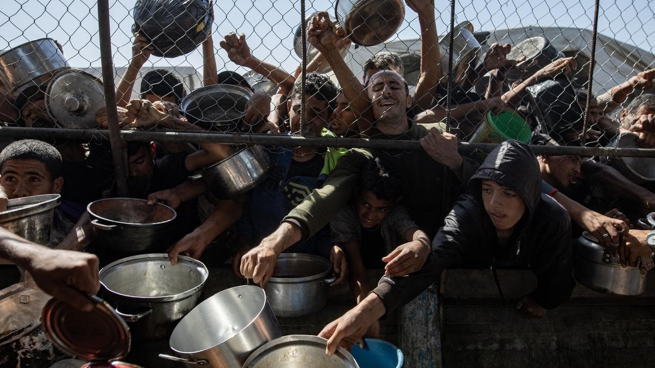 Palestinians gather to receive aid