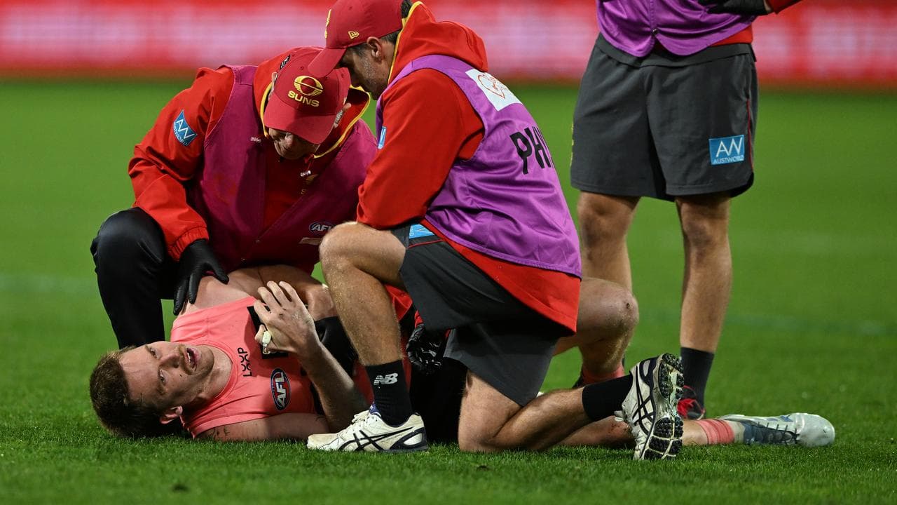 Medical staff check on Gold Coast captain Noah Anderson
