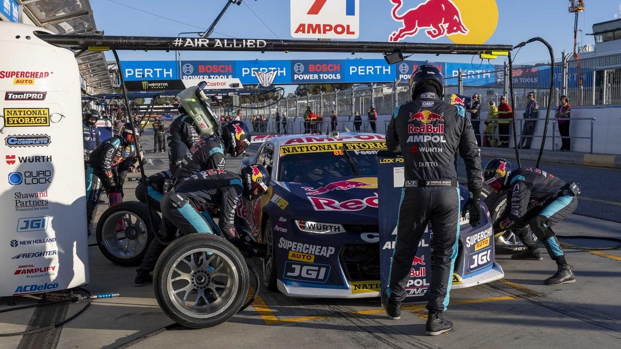 Pit crew members work on Broc Feeney's car