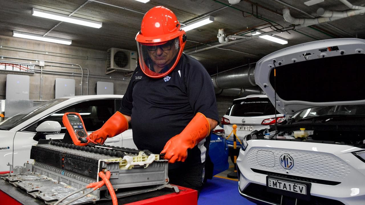 A technician works on an EV battery (file image)