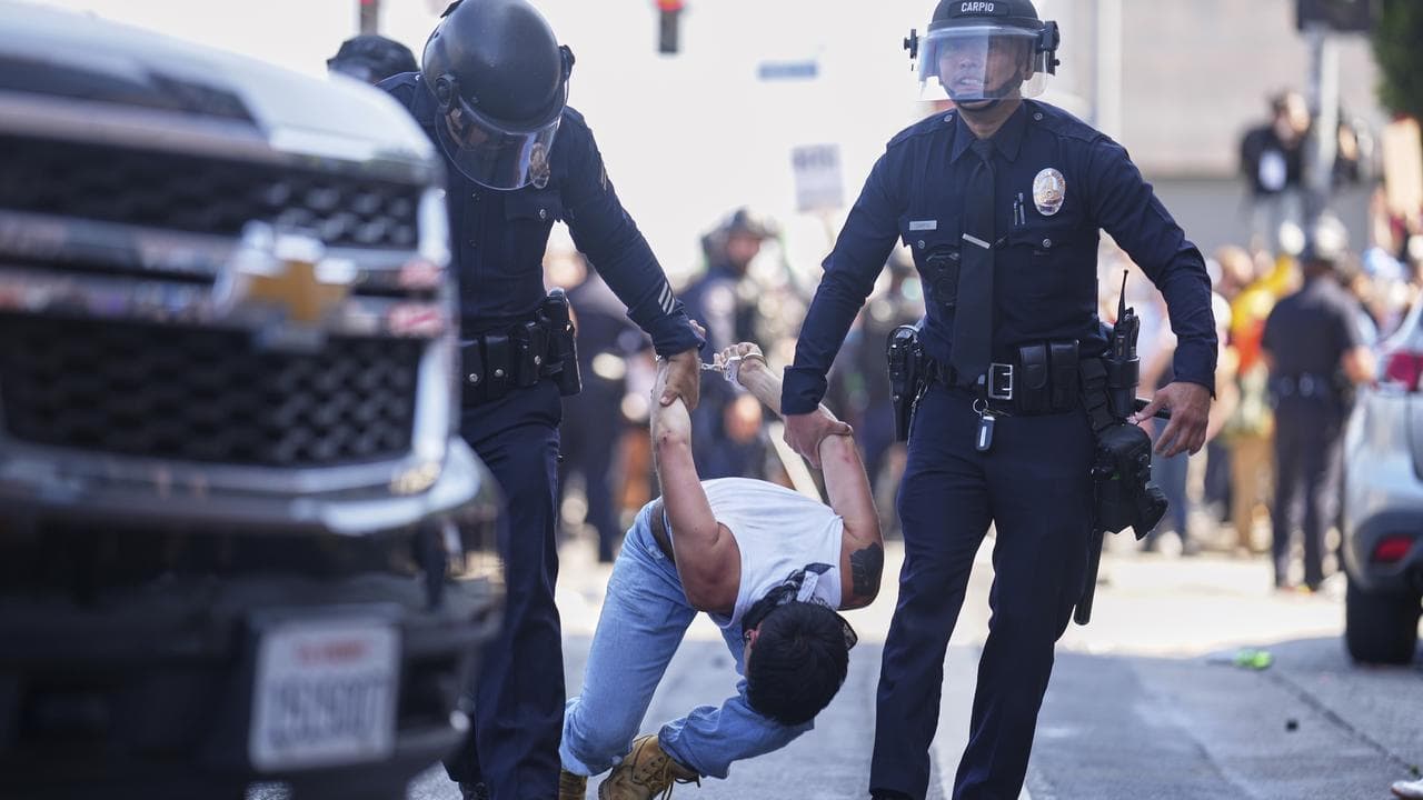 A protester is detained in downtown Los Angeles