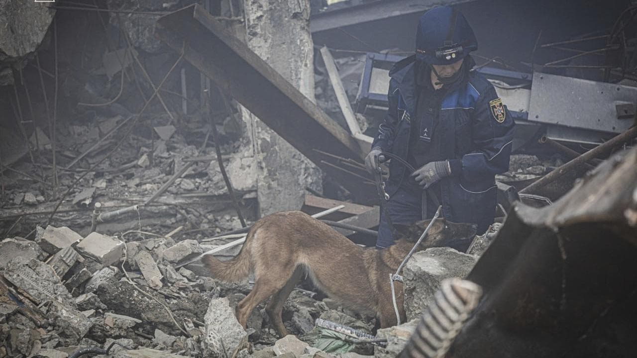 A rescuer searches for victims of a Russian rocket attack in Kharkiv